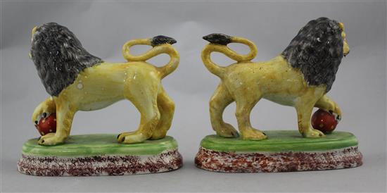 A pair of British pottery figures of lions, c.1820, 16cm., restorations